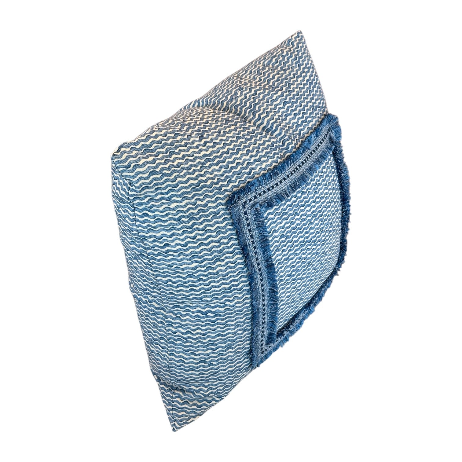 The Sky Popple Outdoor Pillow features a square blue and white pattern, crafted from Fermoie Popple fabric with a front pocket and fringed edging, shown against a white background.