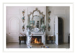 A person in a spacesuit stands near a lit Nick Mele Fine Art S'mores in an elegantly decorated Palm Beach room with white-paneled walls, arched doors, and ornamental items.