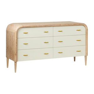 The Pierre Dresser in Pristine Shagreen and Washed Oak features six drawers with light beige fronts, a rounded frame, tapered legs, and gold-toned vintage-style handles.