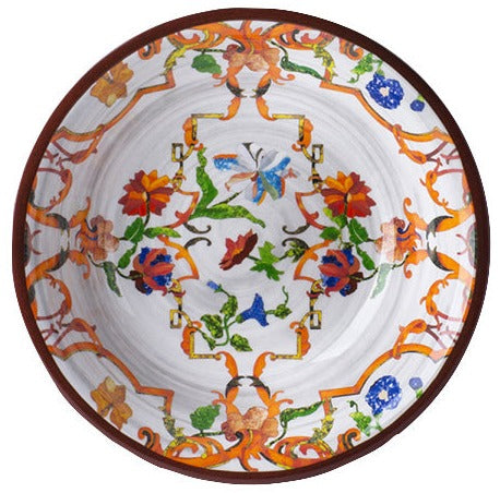 A decorative ceramic plate from the Mario Luca Giusti Pancale White Collection, featuring intricate floral and butterfly patterns in vibrant colors that reflect Mario Luca Giusti's aesthetic research and distinctive modern shapes.