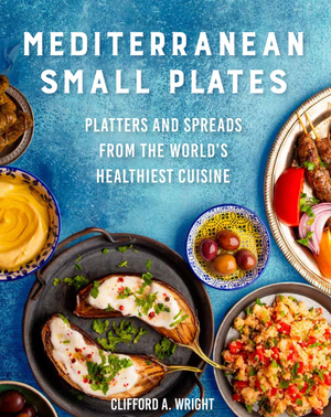 Cover of "Mediterranean Small Plates" by Clifford A. Wright, showcasing an enticing array of Mediterranean food such as stuffed eggplant, bulgur salad, and a skewer with tomato, onion, and olives—perfect for those who enjoy small-plate dining.