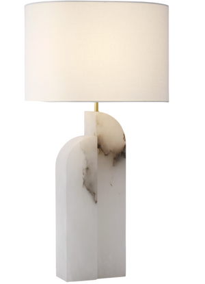 A modern table lamp with a white geometric marble base featuring black veins, and a large white fabric lampshade, this piece from the Savoye Large Left Table Lamp, Alabaster series epitomizes contemporary lighting with its elegant use of natural stone.