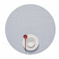 A white bowl and plate with a red spoon sit atop the Mini Basketweave Round Placemat in light gray, viewed from above—a stylish touch for any dining occasion.