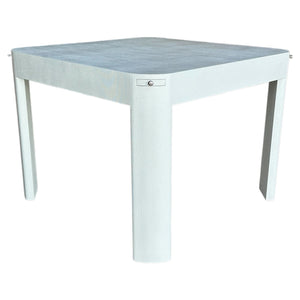 The Custom Textured Grasscloth Game Table features a square, modern design with thick, rounded legs and a minimalist look, finished in marine-grade sea salt paint. Photographed against a plain white background.