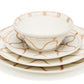 Three cream-colored ceramic dishes with a hand-painted Themis Z Serenity Beige Collection pattern are stacked: a bowl on top of two handcrafted dinner plates, with the design consistent across all pieces.