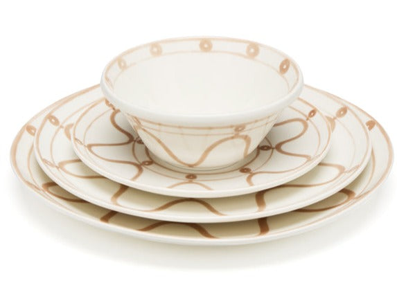 Three cream-colored ceramic dishes with a hand-painted Themis Z Serenity Beige Collection pattern are stacked: a bowl on top of two handcrafted dinner plates, with the design consistent across all pieces.