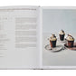 Open cookbook showcasing a recipe for Chocolate Cups Filled with Clementine Mousse on the left page and a photo of three dessert cups on the right, perfect for enthusiasts of The Chocolate Spoon: Italian Sweets From The Silver Spoon.