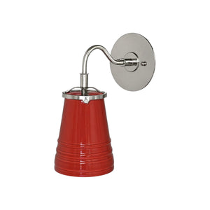 The Nantucket J-Arm Sconce in Pomegranate features a polished metal arm, round base, and a downward-facing red ceramic shade that provides warm ambient lighting.