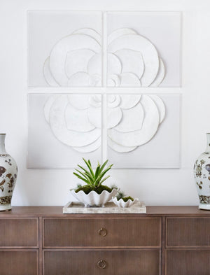 A wooden console table with gold handles displays ceramic vases and succulents, with the White Flower Quadrant four-piece wall art set arranged in a 48" x 48" display above.