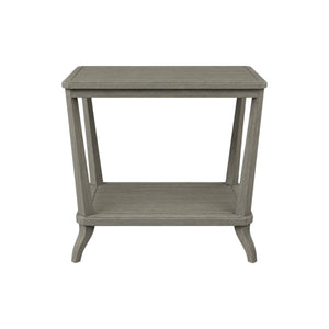 The Rye Rectangular Side Table in Modern French Grey features a weathered stone finish, lower shelf, and subtly curved legs, shown against a white background for a modern touch.