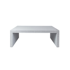 The Lance Coffee Table—rectangular and finished in white gesso with textured, block-like detailing on its legs and edge—is a striking example of contemporary design, making it the perfect addition to modern living room furniture collections.