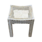 The Cane Stool features an intricately carved wooden frame and a woven cane seat, shown against a white background.