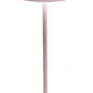 A tall, pink Zafferano Poldina Pro Cordless Lamp with a cylindrical base, a slender rod, and a conical lampshade, providing cordless illumination thanks to its rechargeable battery.