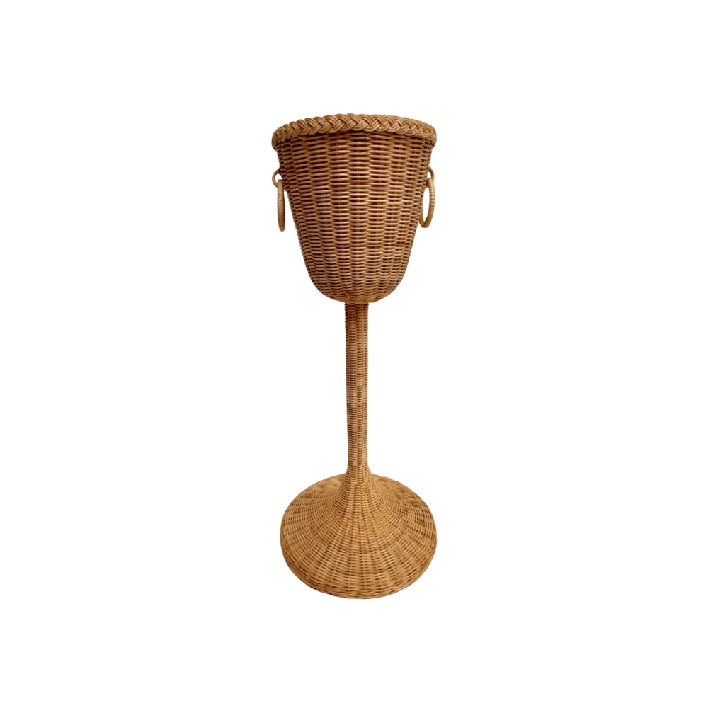 Champagne Stand: Tall woven wicker basket on a stand with two side handles, inspired by classic champagne stands, shown isolated on a white background.
