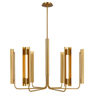 The Carson Six Light Chandelier, Burnished Brass, designed by Kelly Wearstler, features a modern gold aesthetic with multiple cylindrical arms extending in various directions, each holding a vertical light fixture. This piece offers a perfect minimalist combination of elegance and contemporary design.