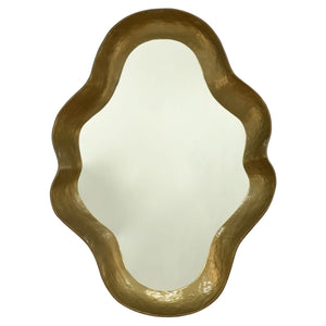 The Venus Mirror in Gold Lacquer features an irregular, wavy frame and a lustrous gold finish, making it a sophisticated statement piece that adds elegance to any room.