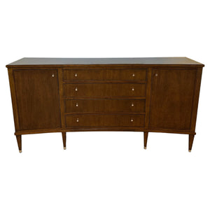 The Smithson Sideboard is a mid-century modern wooden piece featuring four central drawers, two side cabinets, antique silver hardware, and tapered legs—ideal for stylish dining storage.