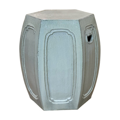 The Natural Mineral Glazed Solid Hexagonal Stool features a light gray finish, paneled sides, and a small circular cutout, offering an antique look inspired by traditional dragon kiln craftsmanship.