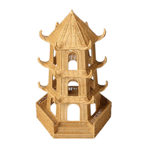 The Bardot Pagoda in Light Honey Rattan is a three-tiered piece with a hexagonal base, arched openings, and curved upturned roof edges inspired by traditional Thai architecture.