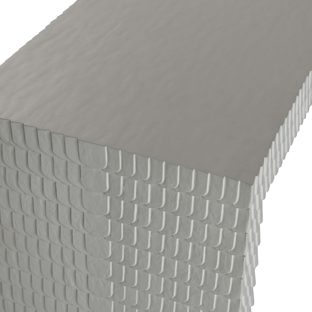 A stack of white paper napkins with a textured, overlapping edge evokes minimalist design—ideal for styling on your Lance Console Table.