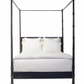 A black Willa Raffia Bed, King with turned bedposts and a white bedding set, including pillows and a duvet.