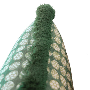 Close-up of a green fabric with white circular patterns and a raised, shaggy green strip running vertically down the center—featured on the Boheme Outdoor Lumbar Pillow, designed with plush polyester fill and a hidden zipper closure for a seamless finish.