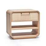 The Marsh Bedside Chest features a light wood finish, a single drawer with a blonde rattan woven front, two open shelves, and rounded corners.