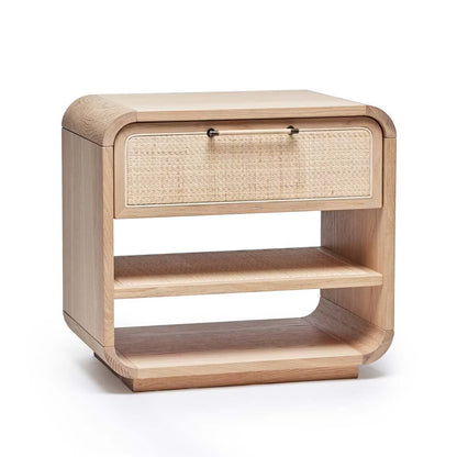 The Marsh Bedside Chest features a light wood finish, a single drawer with a blonde rattan woven front, two open shelves, and rounded corners.