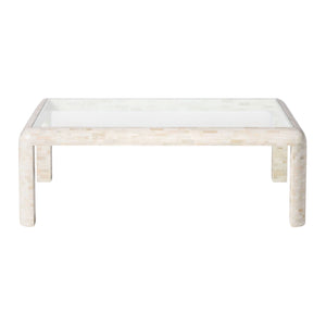 The Harley Natural Bone Coffee Table features a rectangular design with rounded legs, a glass top, and a light-colored tiled base.