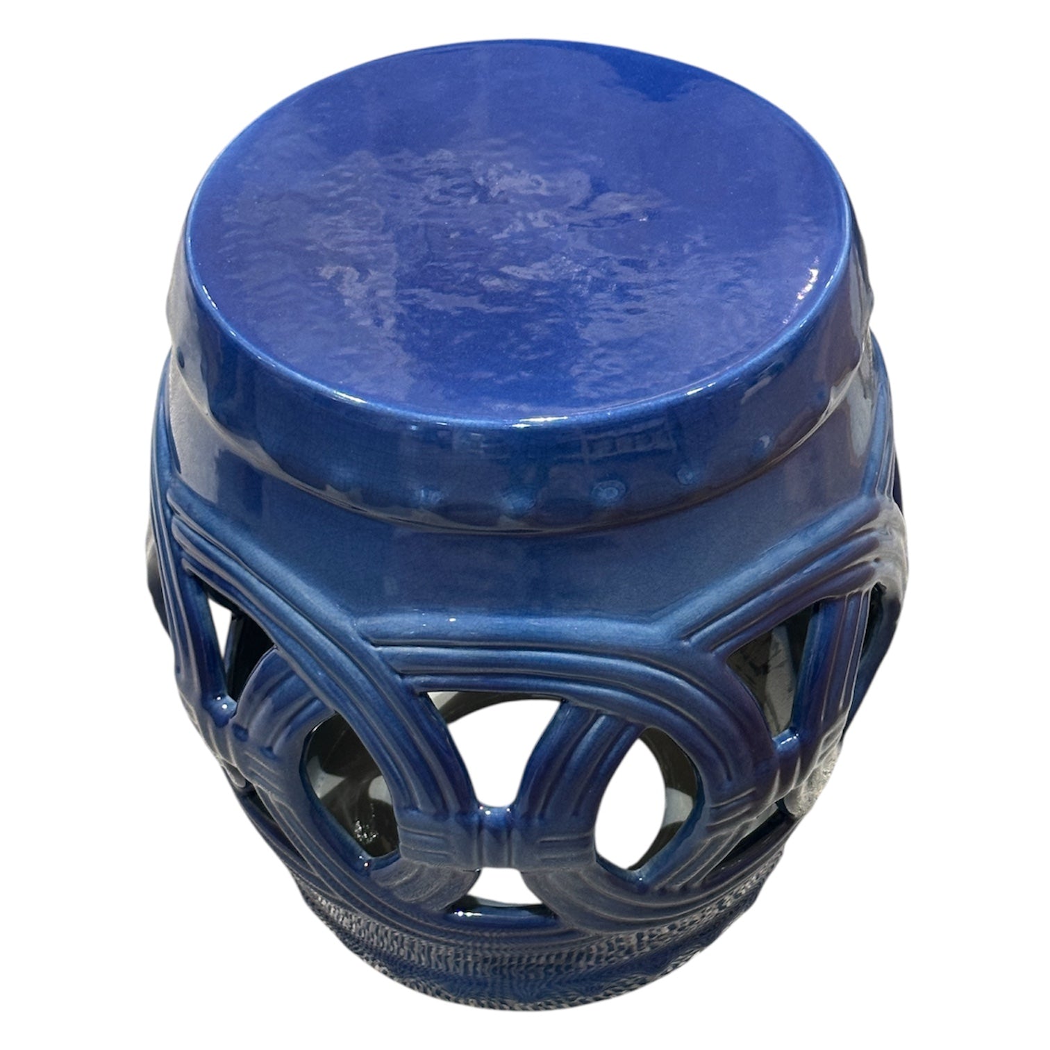 The Dark Blue Circle Garden Stool features a glossy blue ceramic finish, solid top, and decorative openwork sides, presenting an antique look inspired by traditional rustic stools.
