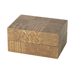 The Navigator Rectangle Box in Antique Brass features a hinged lid and intricate engraved geometric and circular patterns on all sides, making it an elegant decorative piece.