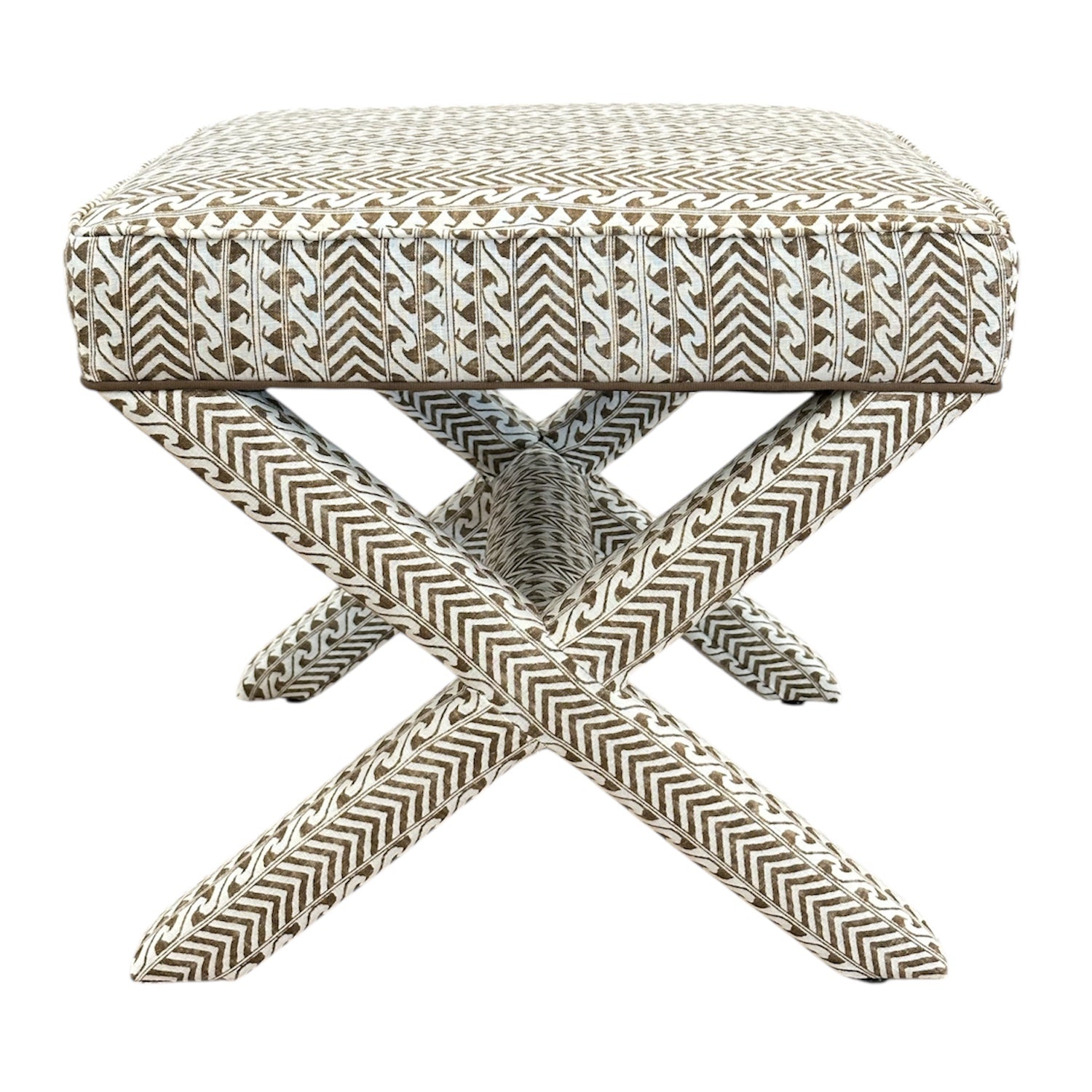 The X Bench is a square upholstered ottoman with custom geometric brown and white fabric and striking X-shaped legs, making it an elegant addition to any space.