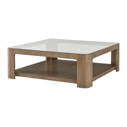 The Marin Cocktail Table in Almond features a square oak veneer design with a glass top and an open lower shelf.