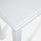 Close-up view of the corner of the Wylder Console, a white rectangular table with a textured surface and simple trim detail—a sophisticated piece that embodies timeless classic design.