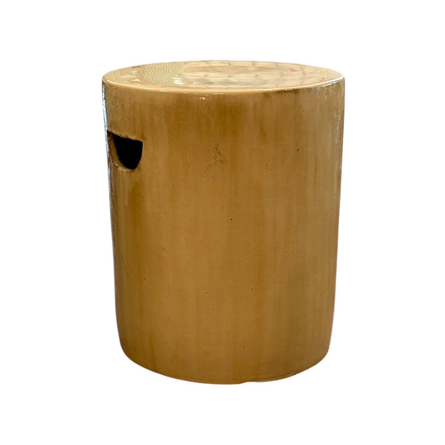 The Cylinder Stool in Latte is a cylindrical, light brown ceramic piece with a small oval cutout handle on the side, featuring a rustic antique look against a white background.