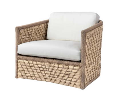 The Capitola Swivel Lounge Chair features woven rattan construction, white seat and back cushions, straight arms, and a boxy silhouette.