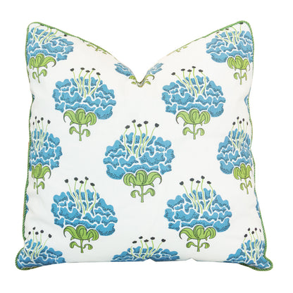 Introducing the Peony Bluebell Pillow: a square white pillow adorned with a repeating blue and green floral pattern and accented by green piping along the edges. This custom-made pillow features a hidden zipper closure for easy care and a seamless finish.