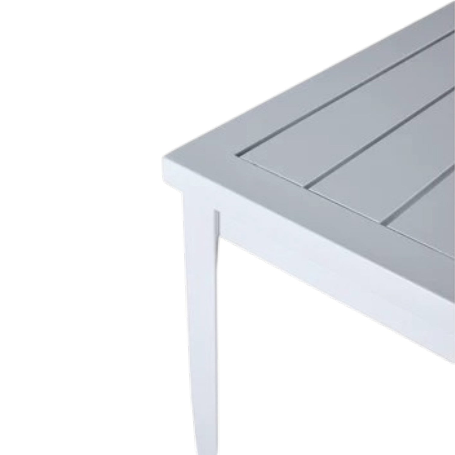 A close-up view of the corner of the Brookings Square Dining Table, featuring a white, weather-resistant finish, slatted tabletop, and tapered legs.