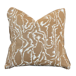 The Tilda Acorn Pillow is a square throw pillow featuring a tan and white abstract wavy line pattern on fabric, with a hidden zipper closure, displayed against a plain white background.